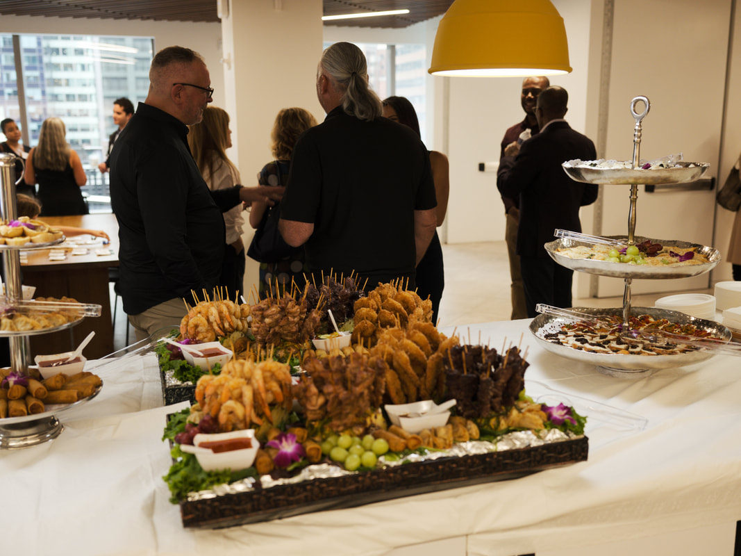 Guests connecting over refreshments at the September 2025 Networking for a Cause event in New York City
