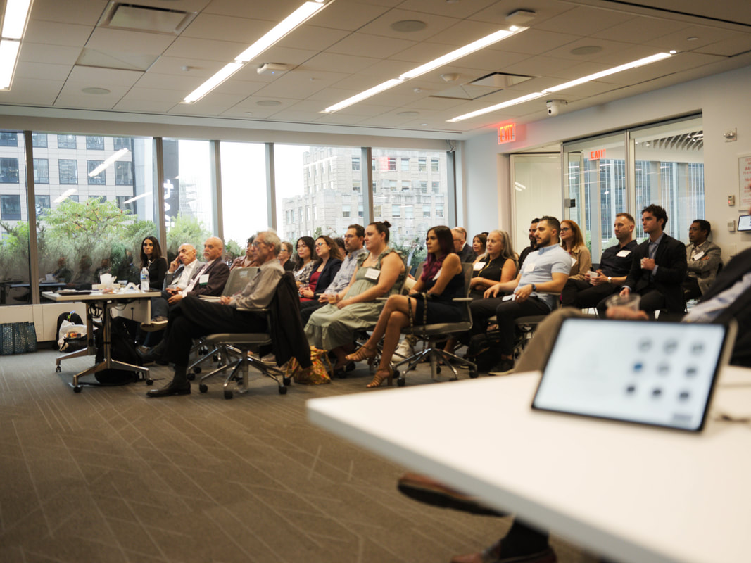 Guests listening to a presentation during Networking for a Cause in 2025