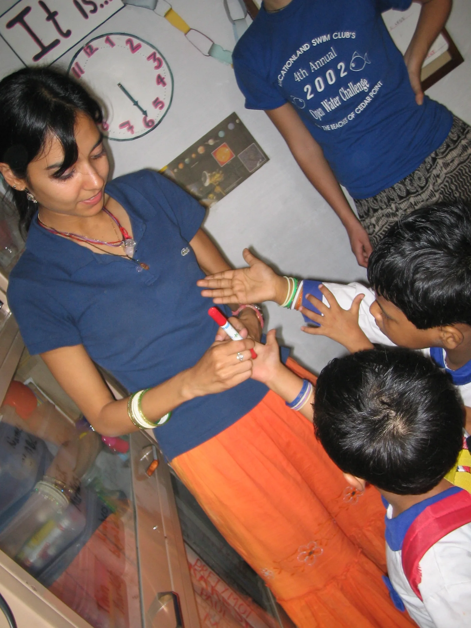 Tanya Pinto helping a child during a classroom activity at Shishu Bhavan