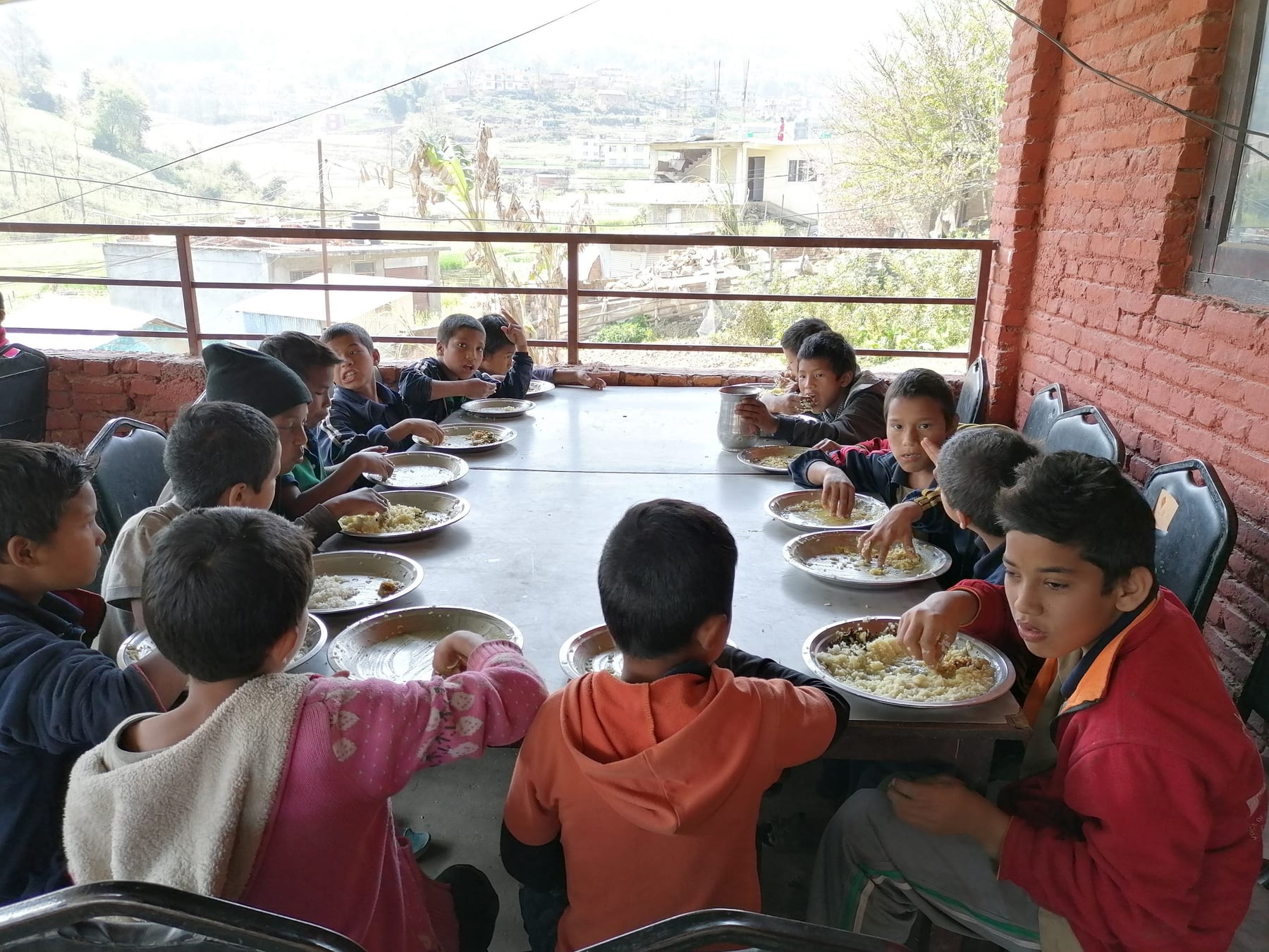 Children sharing a nutritious meal at a partner program in Nepal