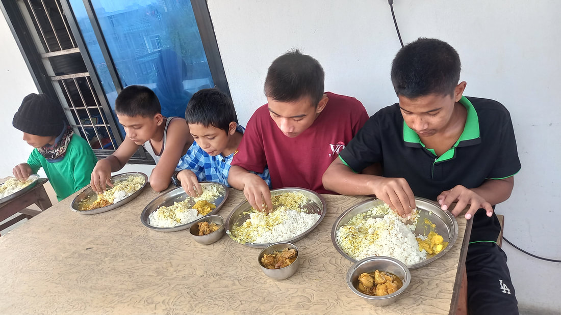 Children sharing a nutritious meal at a Voice of Children shelter in Nepal